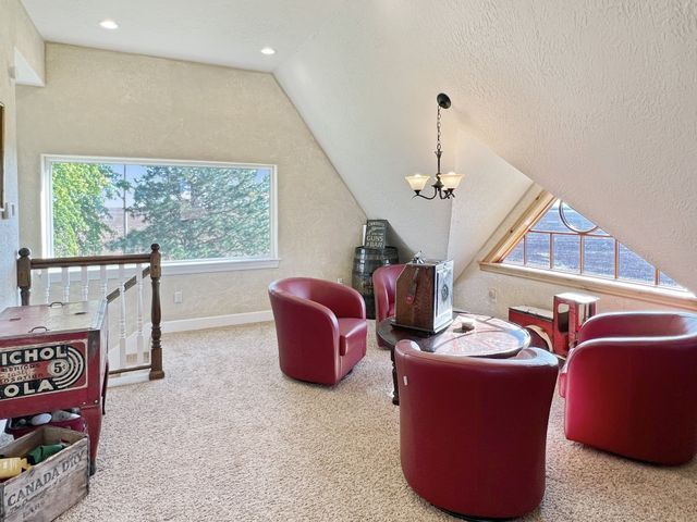 A living room with red chairs and a sign that says michol 's cola