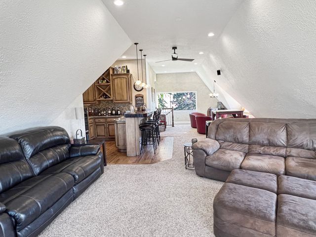 A living room with two couches and a ceiling fan.