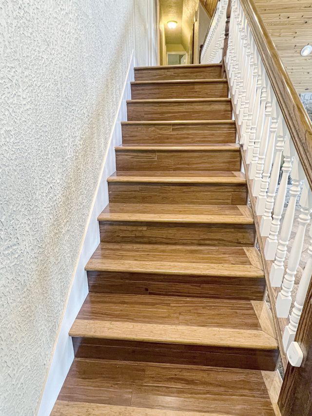 The stairs are made of wood and have a white railing.