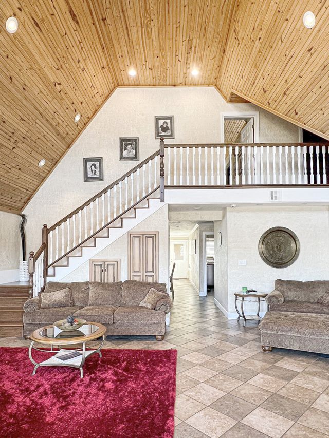 A living room with a couch , coffee table , and stairs.