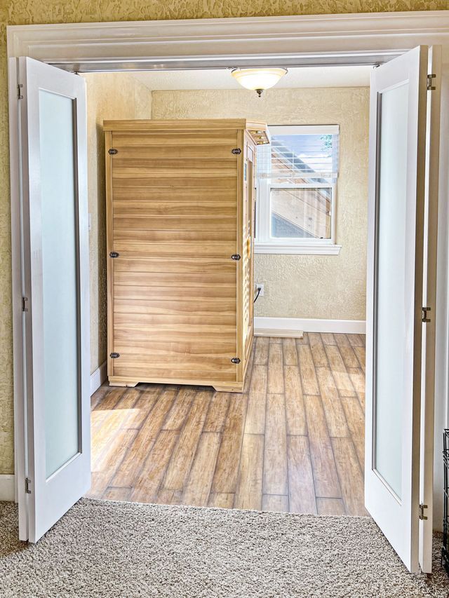 A room with a wooden cabinet and a window