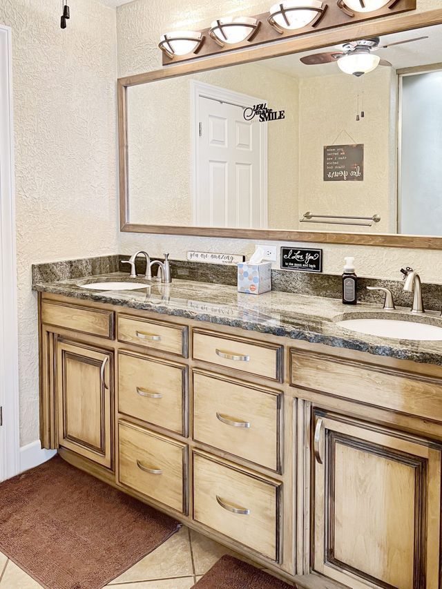 A bathroom with two sinks and a large mirror