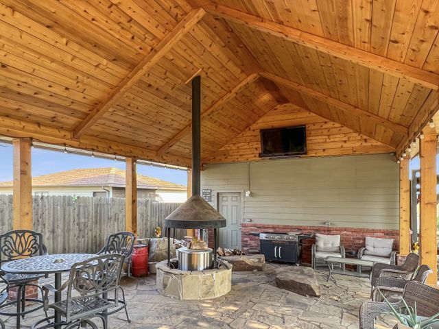 There is a fireplace in the middle of the patio area.