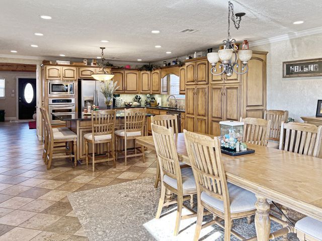 A kitchen with a table and chairs in it