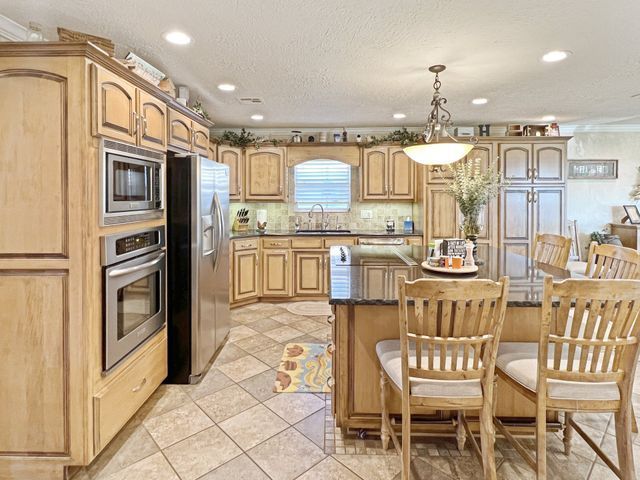 A kitchen with stainless steel appliances and wooden cabinets