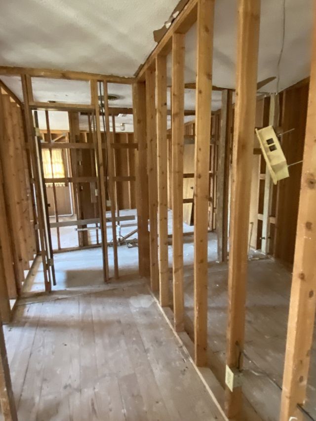 A room that is being built with wooden beams and a ladder.
