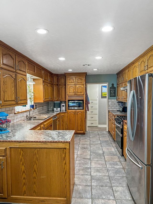 A kitchen with wooden cabinets and stainless steel appliances.