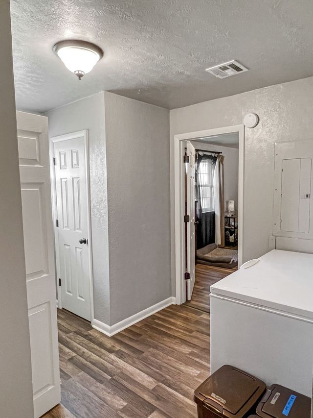 A laundry room with a washer and dryer and a refrigerator.