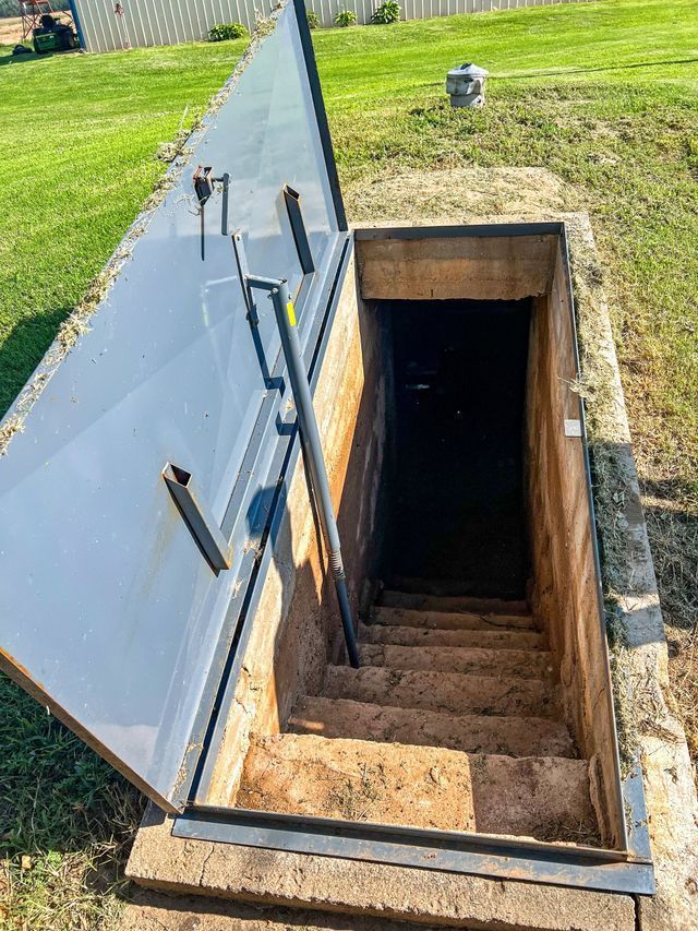 A staircase leading up to a basement with the door open.