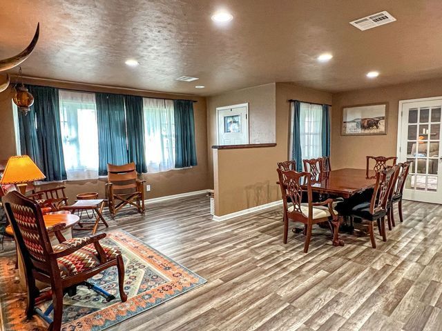 A living room with a table and chairs in it.