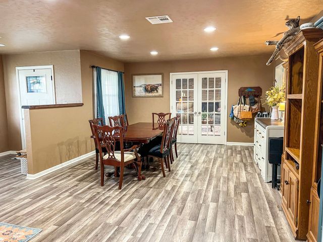 There is a dining table and chairs in the middle of the room.