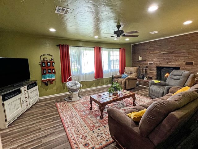 A living room filled with furniture and a television.