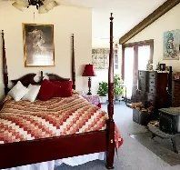 There is a four poster bed in the middle of the room.