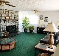 A living room filled with furniture and a fireplace.