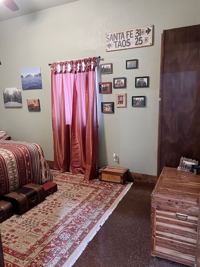 A bedroom with a sign on the wall that says santa fe tacos