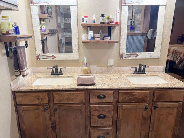 A bathroom with two sinks and two mirrors.