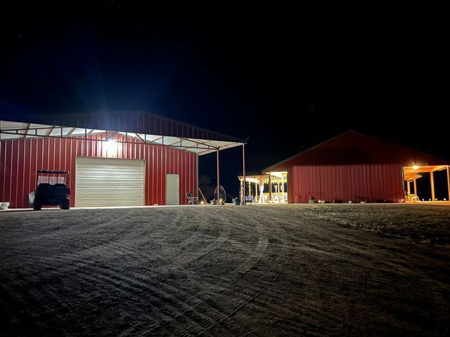 A couple of red buildings are lit up at night.