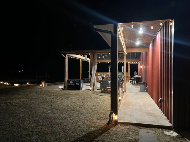A house with a covered porch is lit up at night