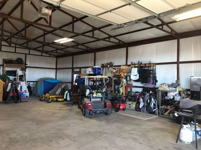 A garage filled with lots of items including a golf cart