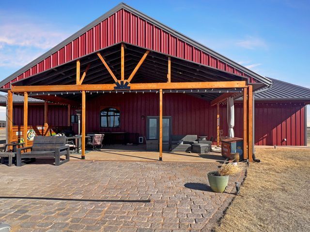 A large red building with a covered patio in front of it