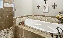 A bathroom with a bathtub and a walk in shower.