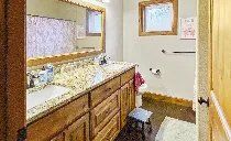 A bathroom with two sinks , a mirror and a tub.