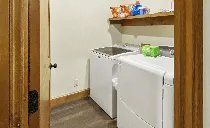 A laundry room with a washer and dryer and a sink.