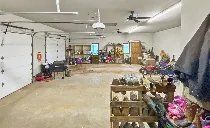 A large garage filled with lots of shoes and clothes.