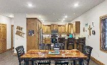 There is a dining table and chairs in the middle of the room.