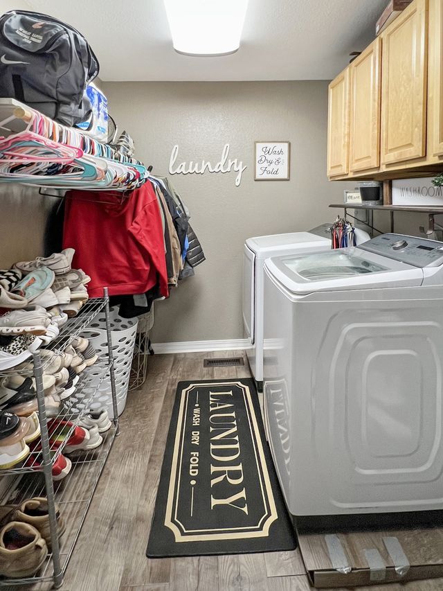 A laundry room with a washer and dryer and a rug.