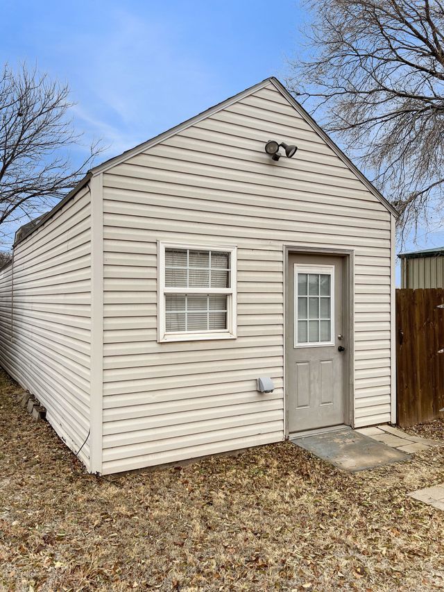 A small white house with a window and a door.