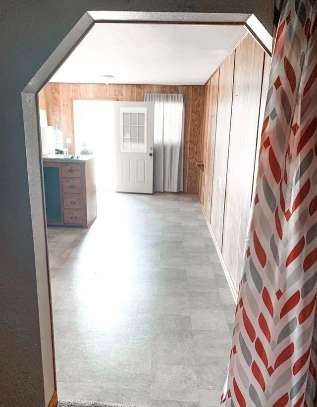 A hallway with a chevron patterned curtain hanging on the wall