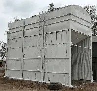 A large white building with a ladder on the side of it.
