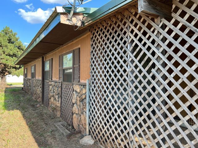 A house with a wooden lattice on the side of it