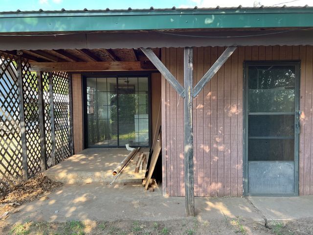 A house with a screened in porch and a sliding glass door