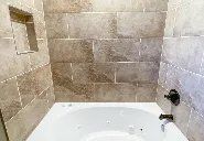 A bathroom with a bathtub and a shower.