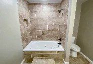 A bathroom with a jacuzzi tub and a toilet.