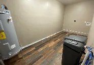 A laundry room with a washer and dryer and a water heater.