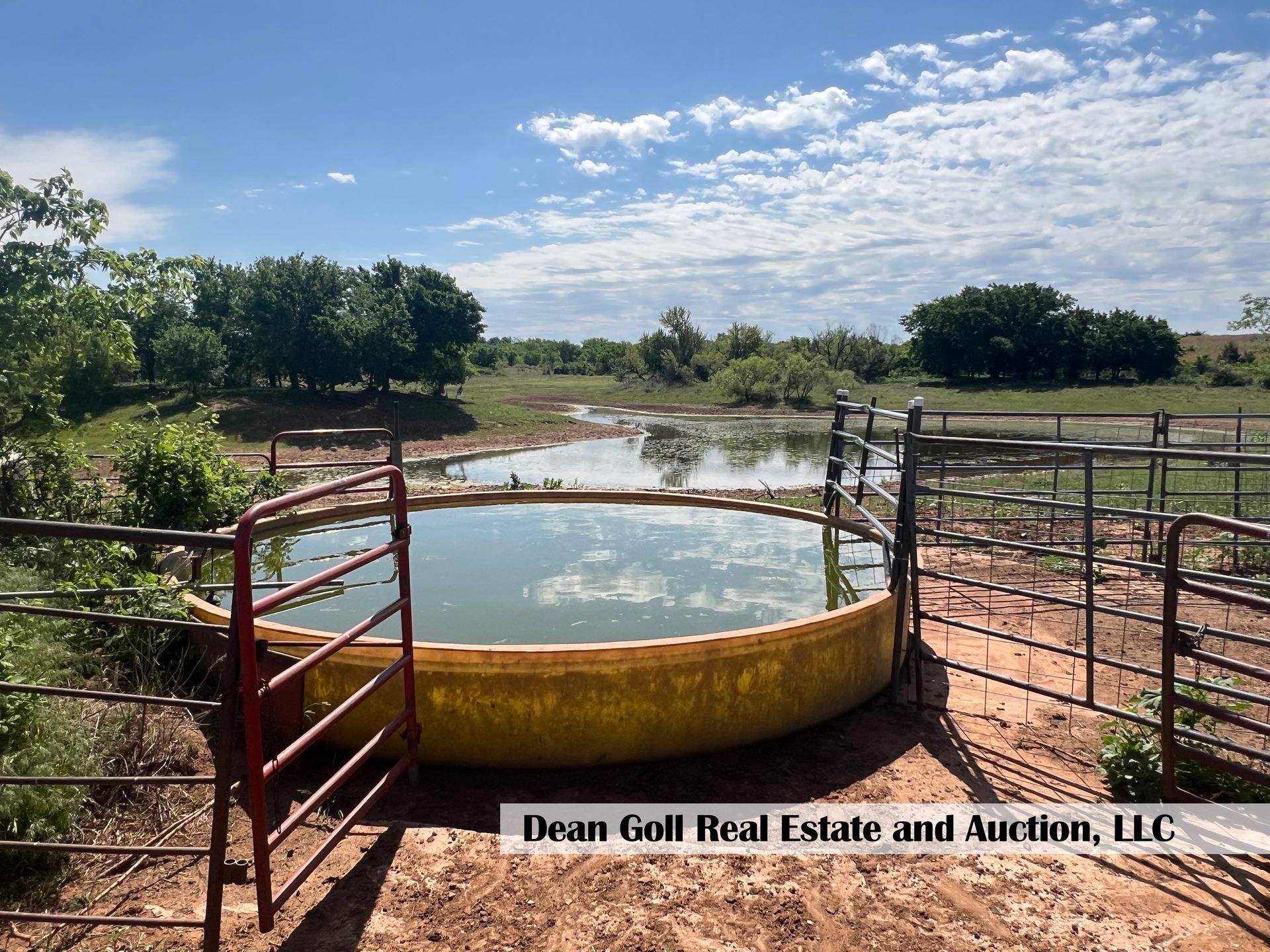 A large pool of water is surrounded by a fence