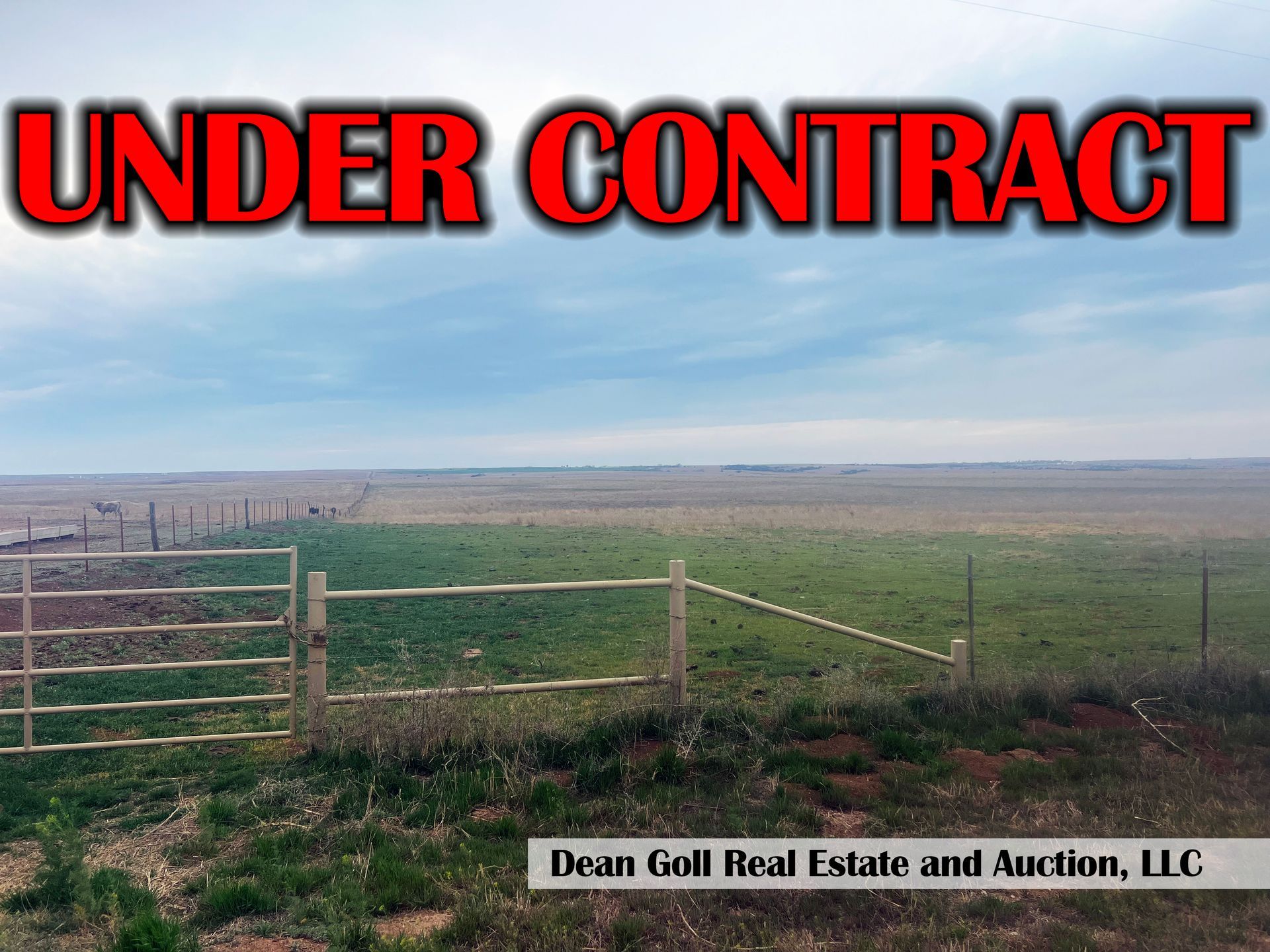 A view of a field featuring a partially constructed fence
