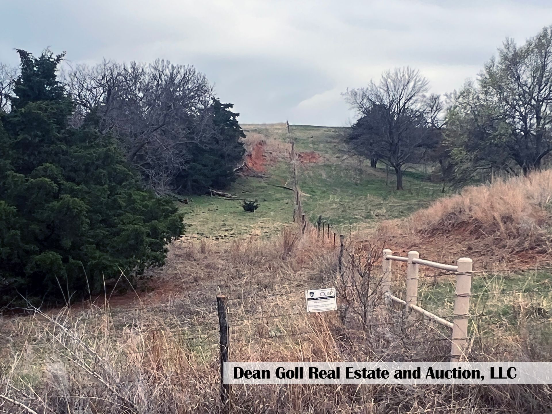 A field with a wooded fence