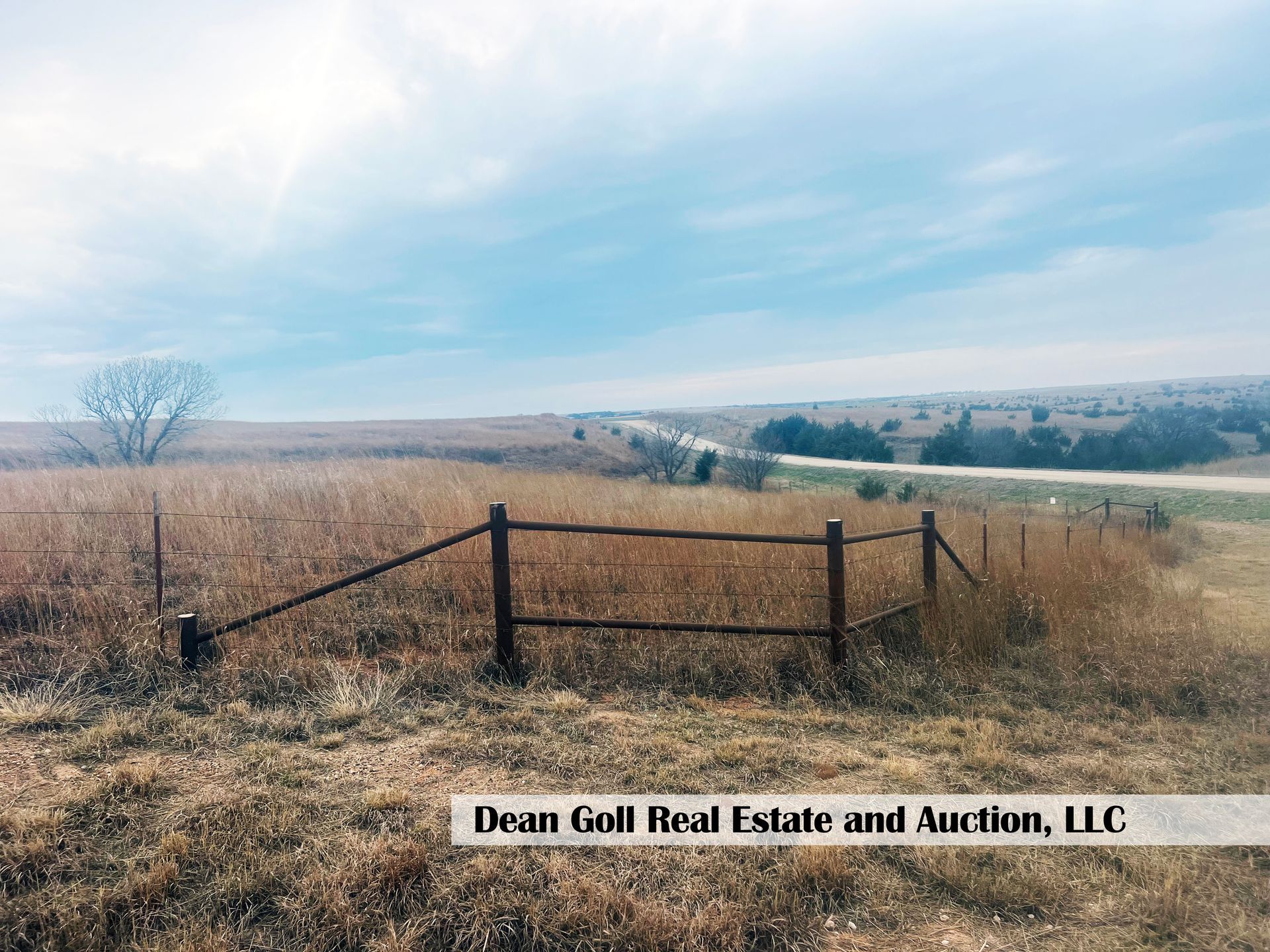 A view of a field featuring a partially constructed fence
