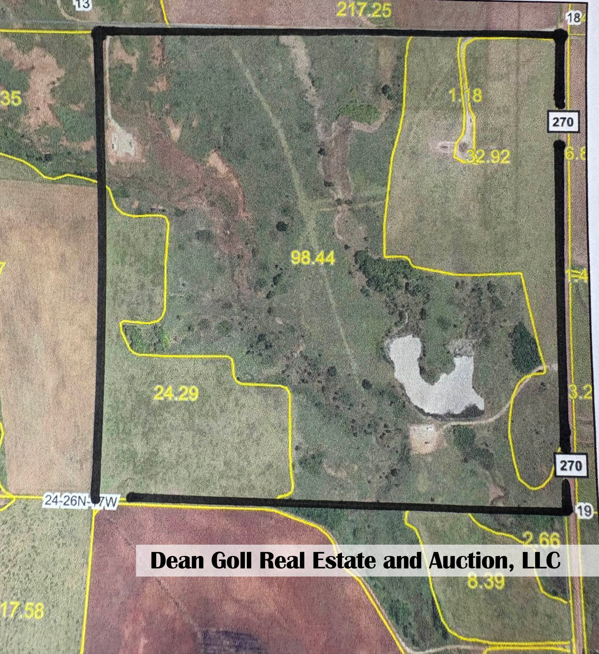 Aerial view of land parcel showing acreage and property lines, with a logo for Dean Goll Real Estate and Auction.