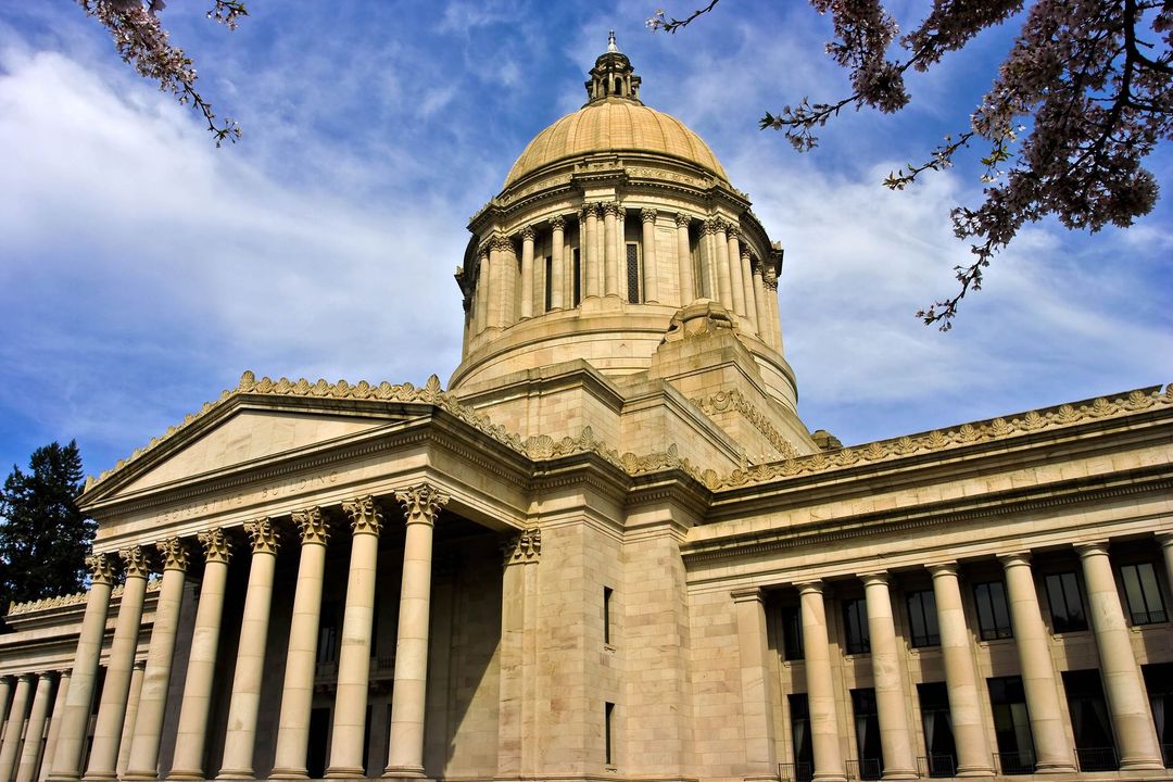 State capitol building with a golden dome and classical columns under a blue sky