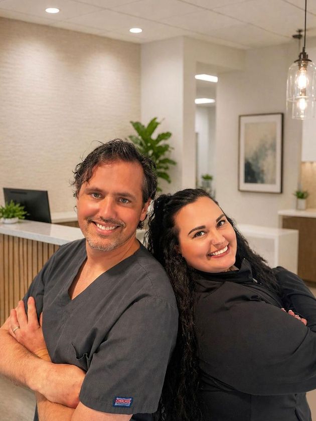 Dr. Sedon and Brittany stand back-to-back, each with their arms crossed.