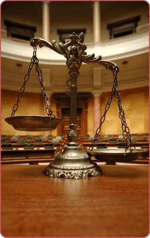 Bronze scale of justice in a courtroom