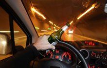 Driving with a bottle of liquor on his hand