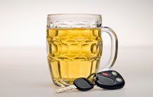 Beer with a car key on its side