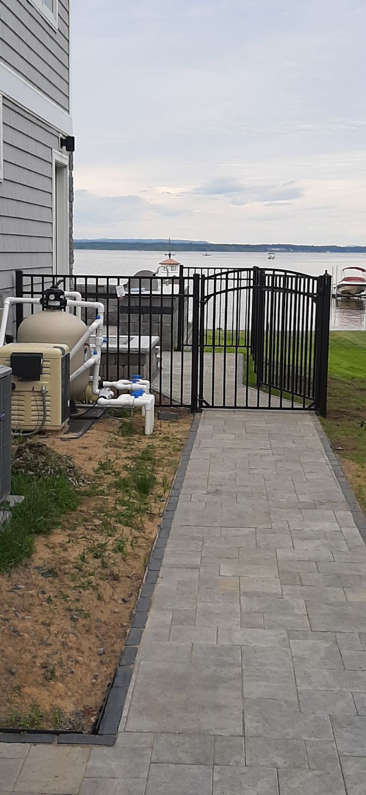 A walkway leading to a house with a gate