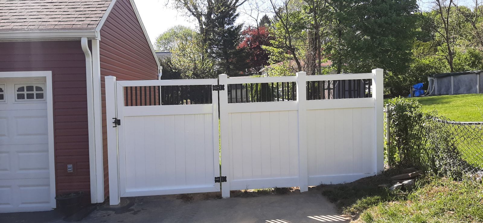 A white fence next to a garage